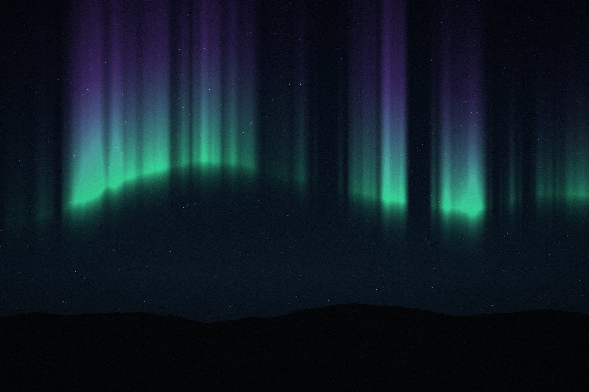 Aurora curtains over a dark ridge line